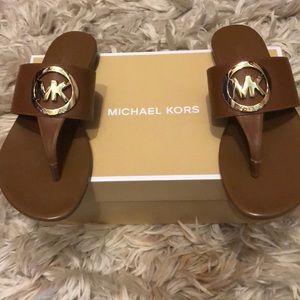 Brown Leather Michael Kors Racquel thong sandals.